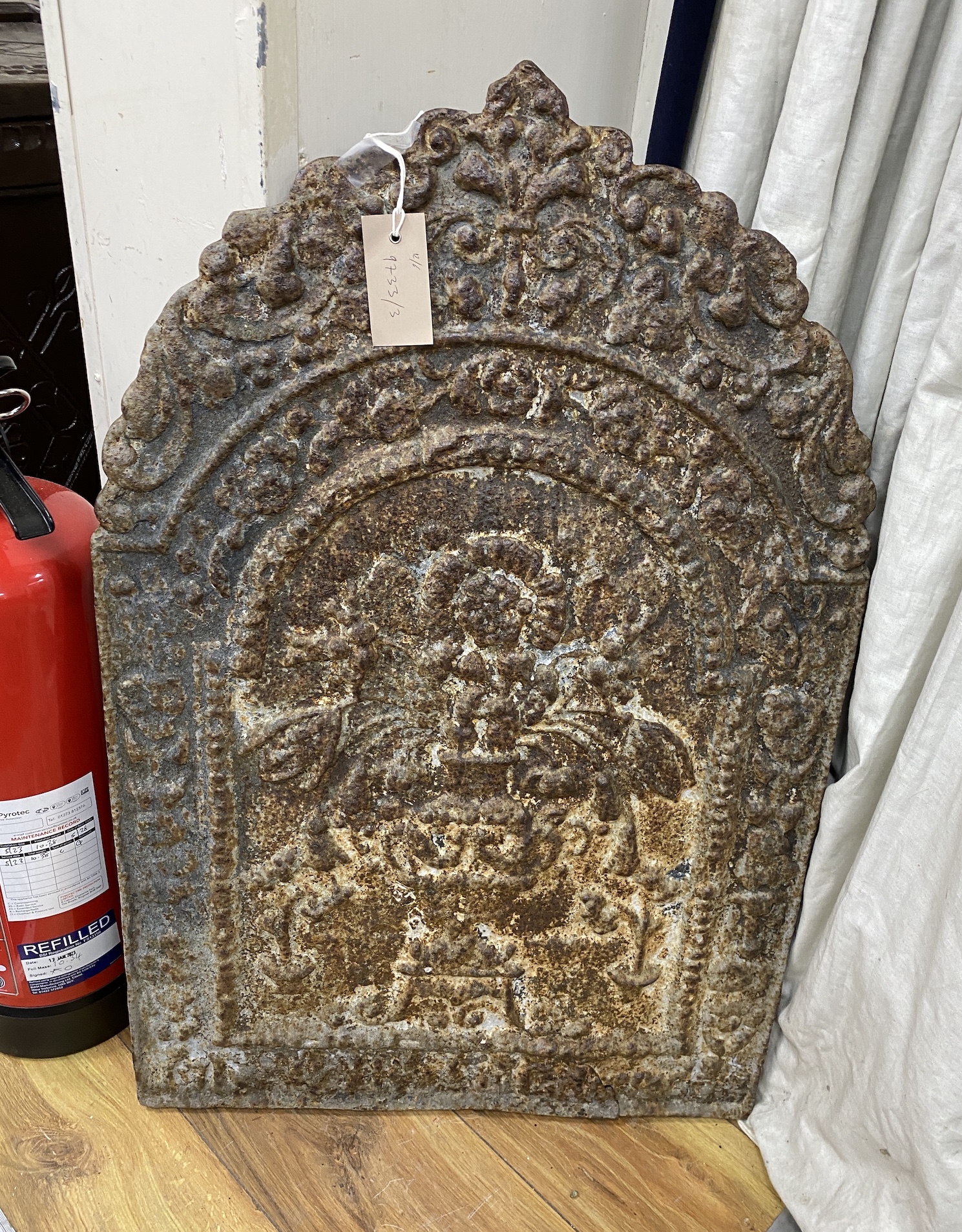 A Victorian cast iron fireback, width 49cm, height 76cm